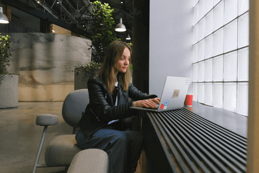 Young woman working on a laptop in a modern office